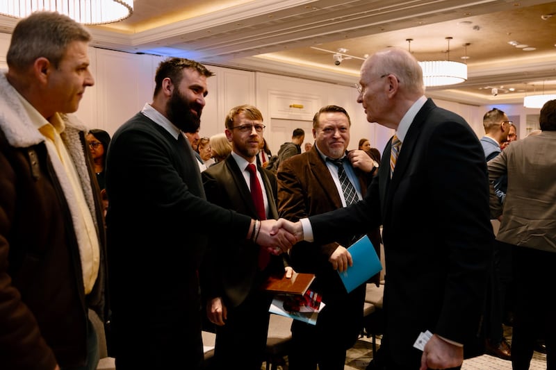Elder Dale G. Renlund of the Quorum of the Twelve Apostles shakes hands with Alin Ardeleanu, an Orthodox priest, at the Romania Bucharest District Conference on Feb. 22, 2026.