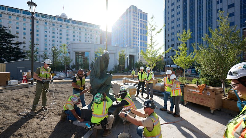 Crew members install the “Jesus Christ in Gethsemane” statue, created by wife-and-husband duo Stephani and Roger Hunt, just south of the Salt Lake Temple on Wednesday, Sept. 17, 2025.