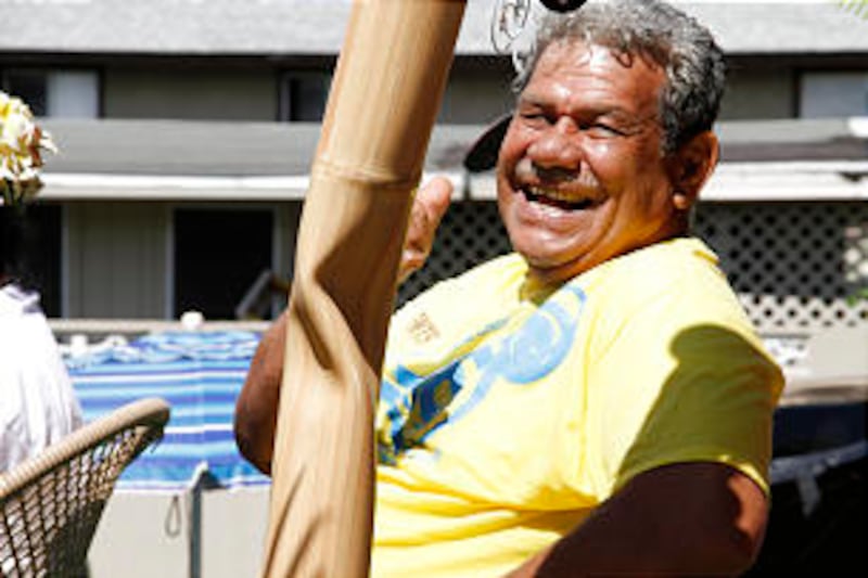 Sione Tulione Pulotu, a 1963 labor missionary, rides float in parade.