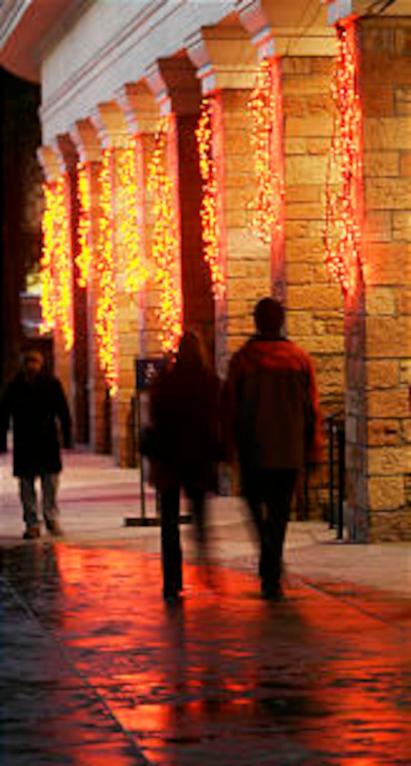 Visitors to Temple Square mingle among the exhibits and lights.