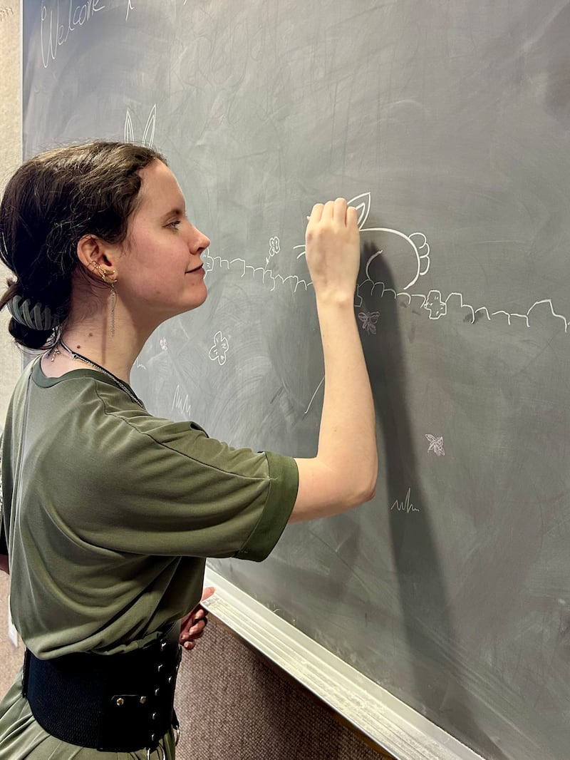 Dakotah Simmons decorates the chalkboard in her ward's Relief Society room on March 8, 2026. Simmons serves as the bulletin board specialist in the Sierra Ranch Ward in the North Las Vegas Nevada Stake.