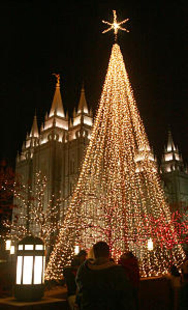 Visitors gets their first look at the lights on Temple Square after they were turned on as part of a