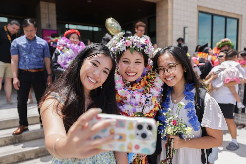 BYU–Hawaii graduates take photos outside the Cannon Activities Center following commencement on Friday, April 17, 2026, in Laie, Hawaii.