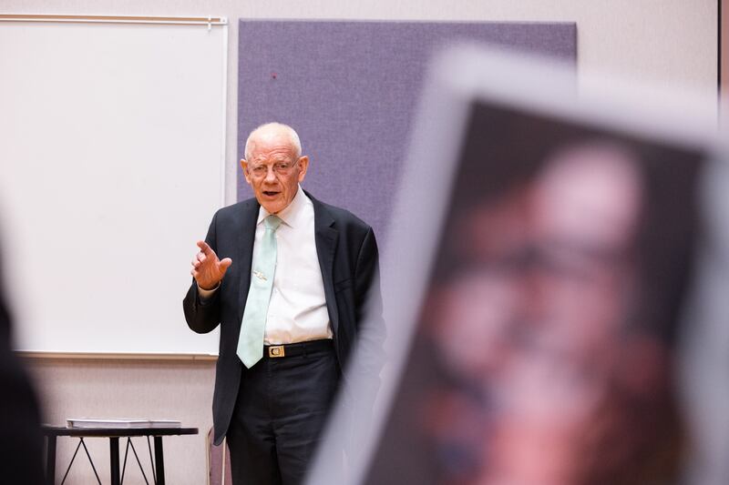 President Cleeo Wright speaks as a photo of his family is handed around during a meeting.