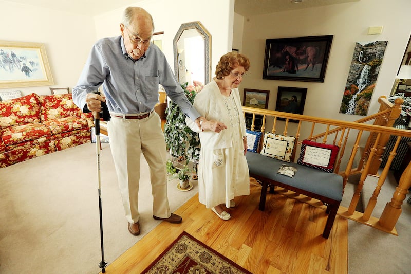 Jim and Colleen Pinegar walk into their living room as they talk at their home in Orem on Tuesday, A