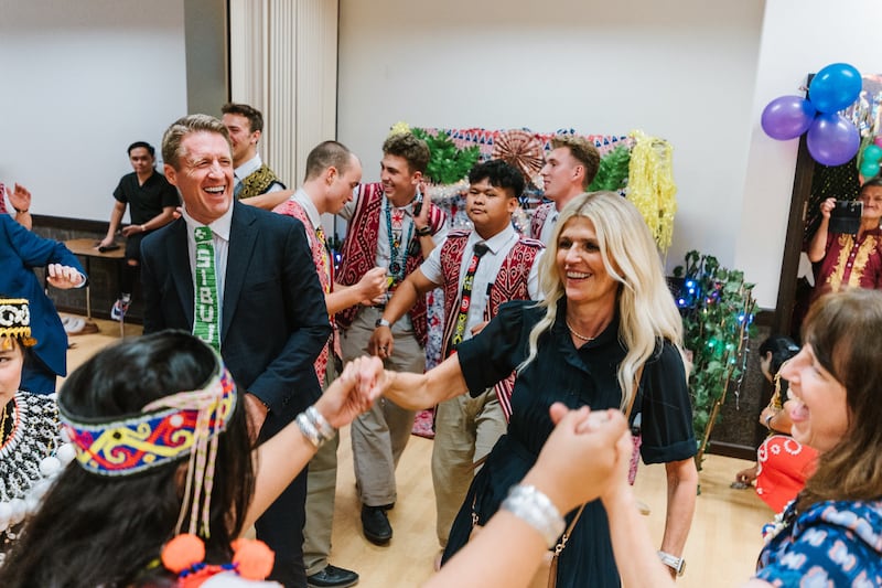 Young Men General President Timothy L. Farnes, left, and his wife, Sister Linsey Farnes, interact with youth during a Gawai harvest festival in Sibu, Malaysia, as part of a ministry assignment to countries in Asia, May 21-31, 2026.