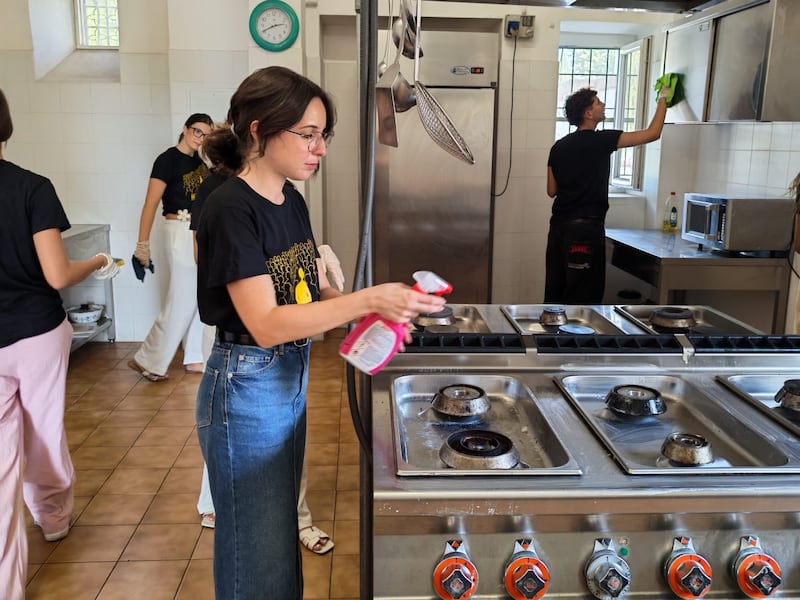 Young single adults from Sicily and Malta clean the kitchen at Casa Scalabrini 634 during a service project in Rome, Italy.