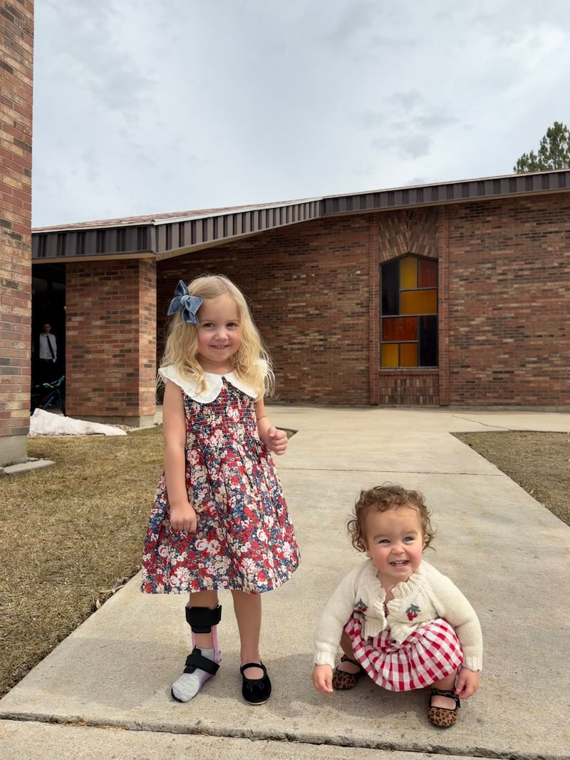 Estelle Santiago, then 3 years old, left, smiles with her younger sister, Bianca, during Estelle's recovery from a severe illness that she contracted in Uruguay in January 2026.