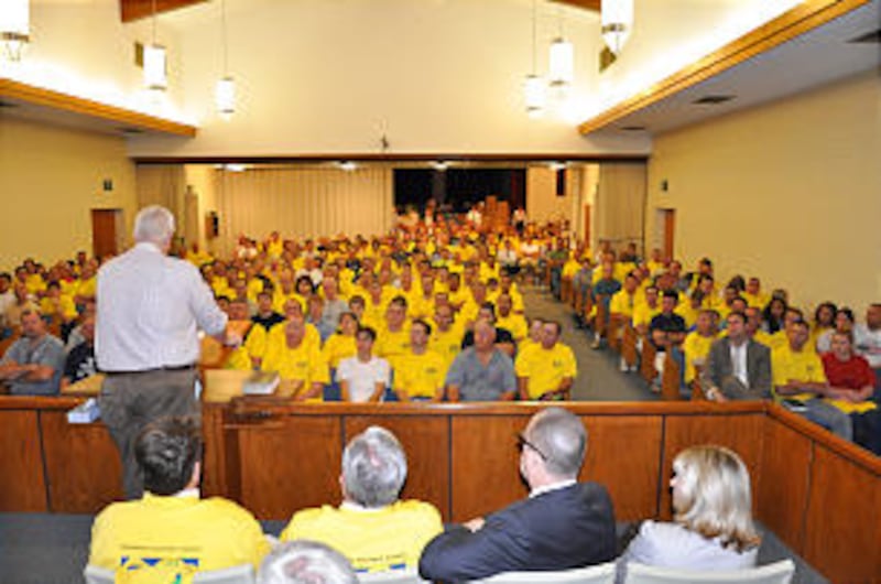 Hundreds of T-shirt clad volunteers squeeze inside the Bessemer Alabama Stake Center to receive inst