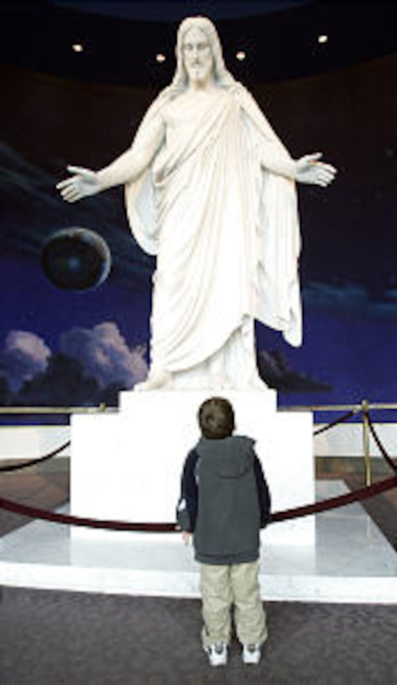 Seth St. Clair, Provo, look at the Christus in the Temple Square visitors center during LDS General