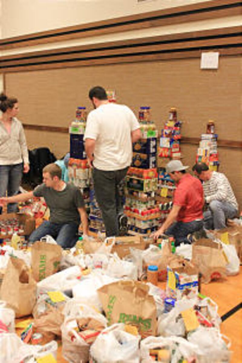 Members from the Willow Creek YSA Ward start building their canned food sculpture.