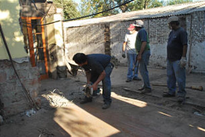 Workers help rebuild.