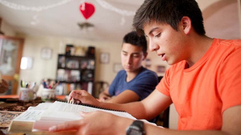 Young men study together during a seminary class in Ecuador.