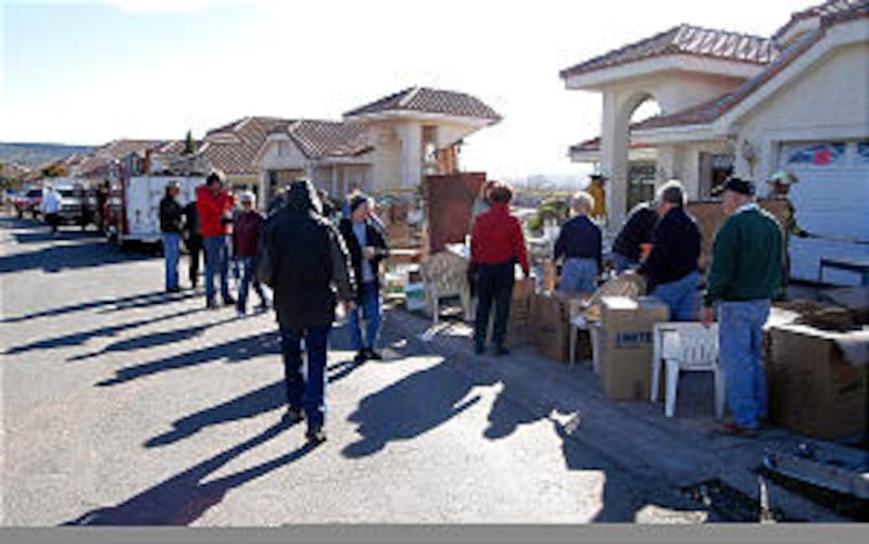 Members arrived early Jan. 15 to help flood victims evacute remaining possessions. Homes along this