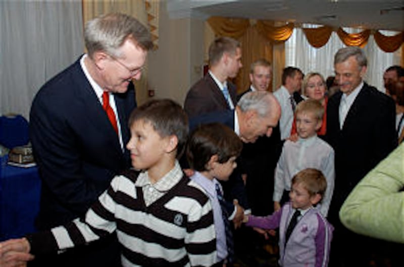 Members greet Elder Russell M. Nelson, center, and Elder Gregory A. Schwitzer following Samara Russi