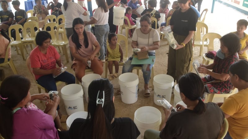 Community members assemble filtration units at Dimantal Elementary School in Bugallon, Pangasinan, Philippines, on April 23, 2026.