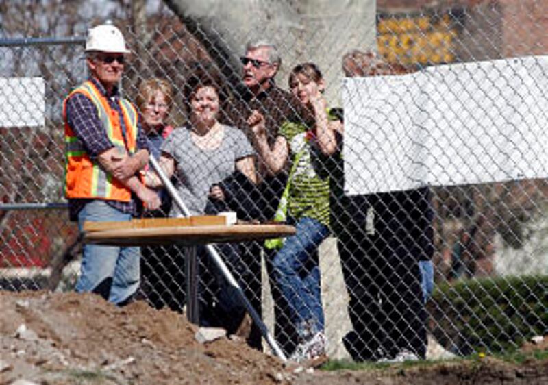 Project archeologist Lane Richens talks to onlookers as they watch excavation work at the site of th