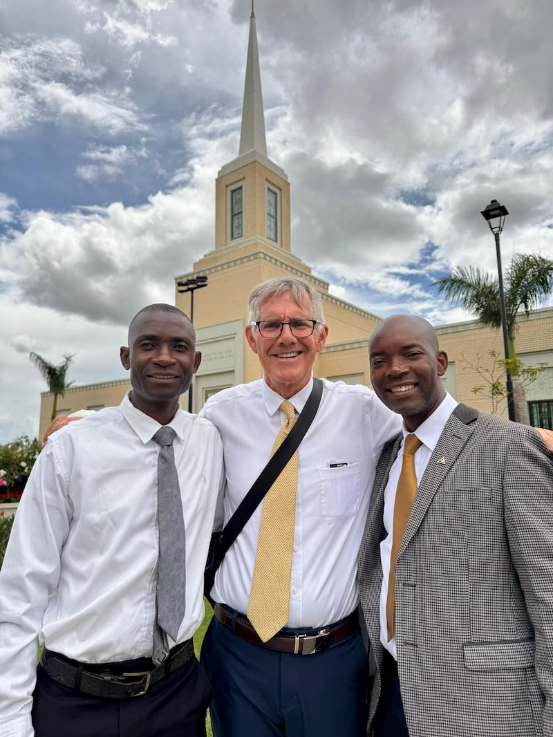 Three men stand outside the Harare Zimbabwe Temple.
