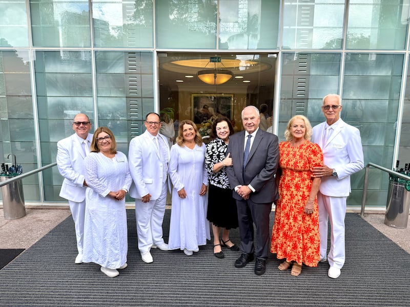 Elder Ronald A. Rasband and Sister Melanie Rasband take a photo outside the Recife Brazil Temple with temple leaders.