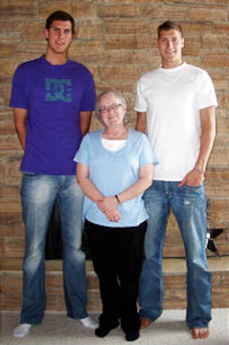Brothers Jordan, left, and Dallin Bachynski tower over Ann Woodruff during a visit in the Bachynski