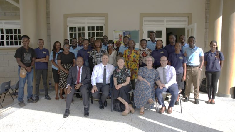 Elder Frederick Kamya, Elder Carl B. Cook, Sister Lynette Cook, Sister Isabelle Giraud-Carrier and Elder Christophe Giraud-Carrier take a picture with YSA leaders in the Kampala Uganda North Stake on March 17, 2026.
