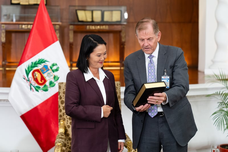 Elder Gary E. Stevenson of the Quorum of the Twelve Apostles of The Church of Jesus Christ of Latter-day Saints gives a copy of the Book of Mormon to Peru President Keiko Fujimori Higuchi, as part of a ministry in the South American country on Thursday, Aug. 27, 2026, at the Government Palace in Lima, Peru.