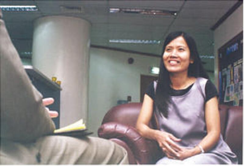Meriam Soriano Erquiza of Manila, Philippines, speaks with official about PEF loan.