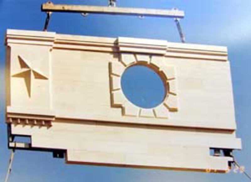 Panel containing stones carved across U.S., and Canada, is hoisted by crane to be bolted to