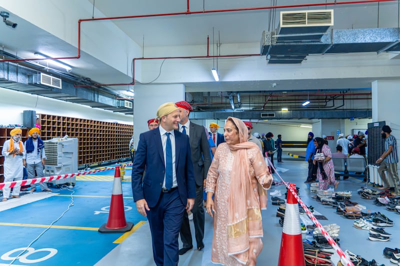 Elder Roland J. Bäck, an Area Seventy, and Bubbles Kandhari, vice chairperson of the Guru Nanak Darbar Gurudwara, visit before a food kit distribution ceremony in Dubai, United Arab Emirates, on Sunday, Aug. 30, 2026. The food kits were assembled by members of the Sikh community and members of The Church of Jesus Christ of Latter-day Saints in a combined service project.