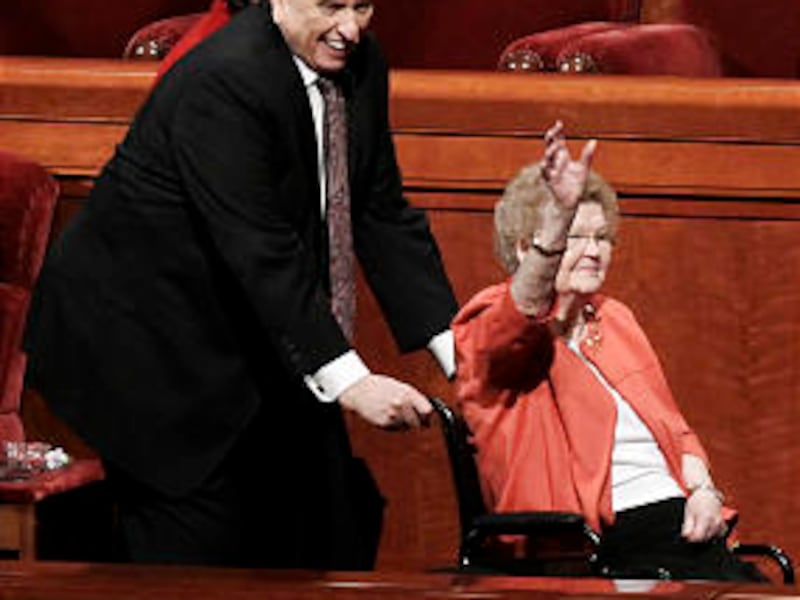 President Thomas S. Monson assists his wife, Sister Frances Monson, out of the Conference Center fol