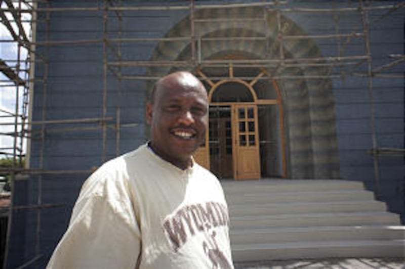 President Ashebir Yirga, first counselor in the Addis Ababa District, stands in front of the new mee