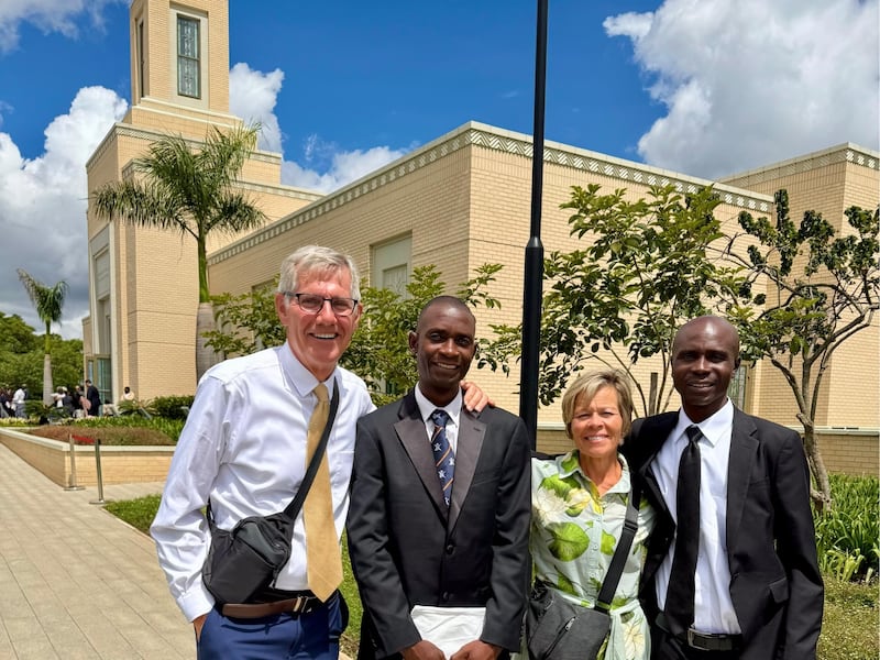 Kilford Shereni and Reginald Magocha pause for a photo with Bruce and Elizabeth Anderson outside the Harare Zimbabwe Temple.