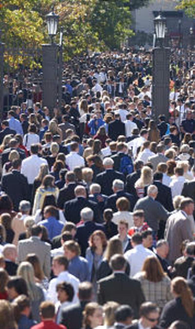 People mill out of the Conference Center an into Temple Square after the first Sunday session of the