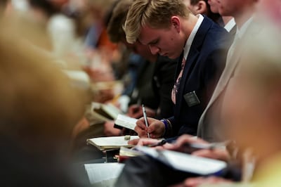 Missionaries take notes during a devotional at the Provo Missionary Training Center in Provo, Utah on Tuesday, May 10, 2022.