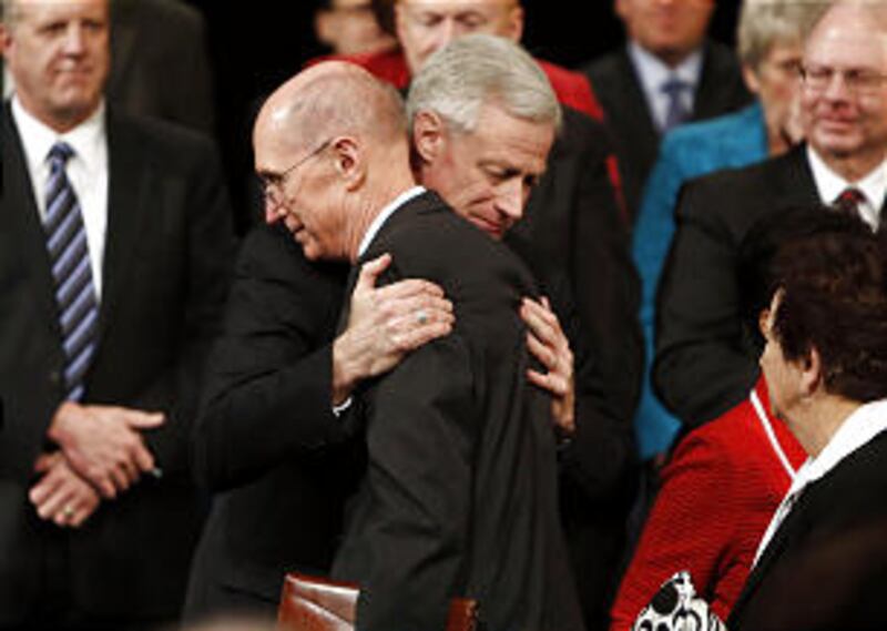 Kevin J Worthen hugs President Henry B. Eyring, first counselor in the First Presidency, at the end