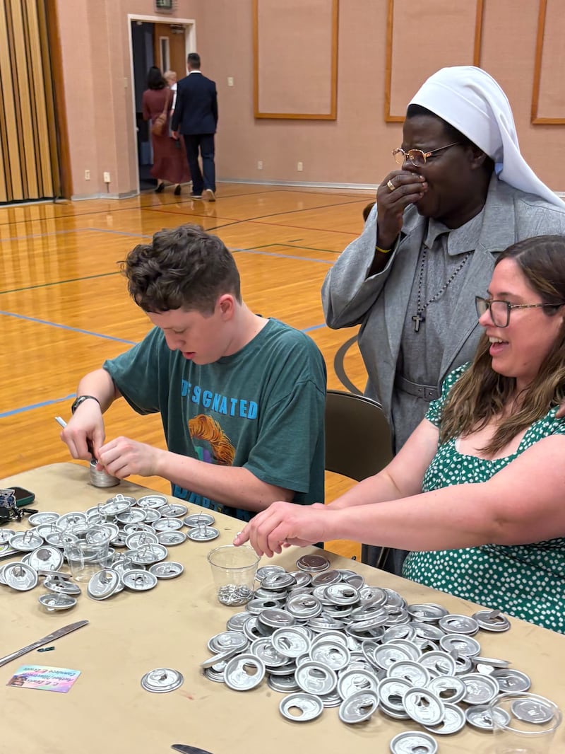 Sister Rosemary Nierumbe is supervising two members of the Norman Oklahoma Stake who will participate in a service project to remove tabs from can lids on March 8, 2026.