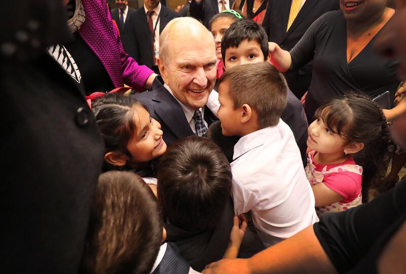 President Russell M. Nelson of The Church of Jesus Christ of Latter-day Saints hugs children after a devotional in Asuncion, Paraguay, on Monday, Oct. 22, 2018.