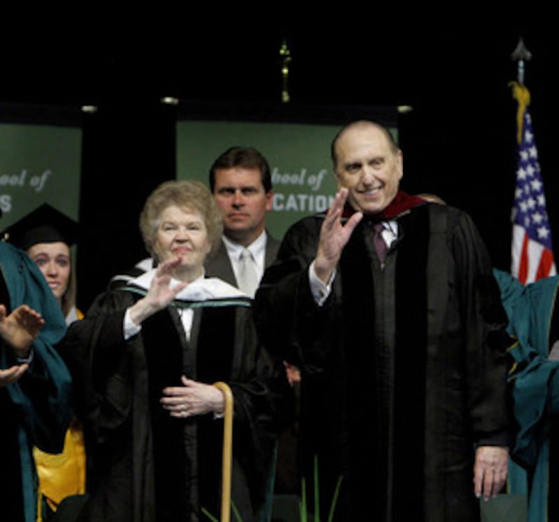 President Thomas S. Monson and his wife, Sister Frances J. Monson, waves to the audience after they