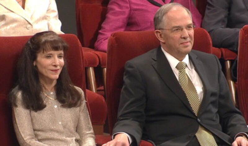 Sister Kathy Andersen and Elder Neil L. Andersen are seated in the Tabernacle prior to his speaking