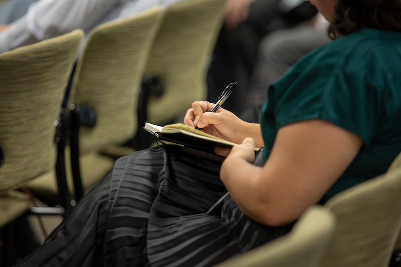 An Ensign College student takes notes during a campus devotional in Salt Lake City on Sept. 22, 2026.