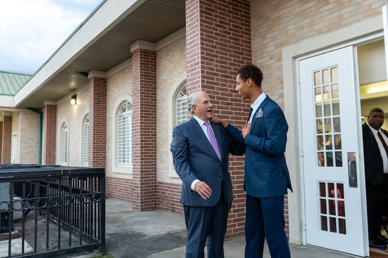 Elder Ronald A. Rasband of the Quorum of the Twelve Apostles greets a missionary while visiting the Dominican Republic in April 2026.