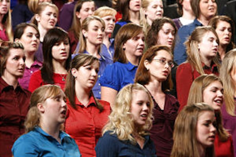 A choir from both BYU and the University of Utah sing at a CES Fireside where Elder Robert D. Hales