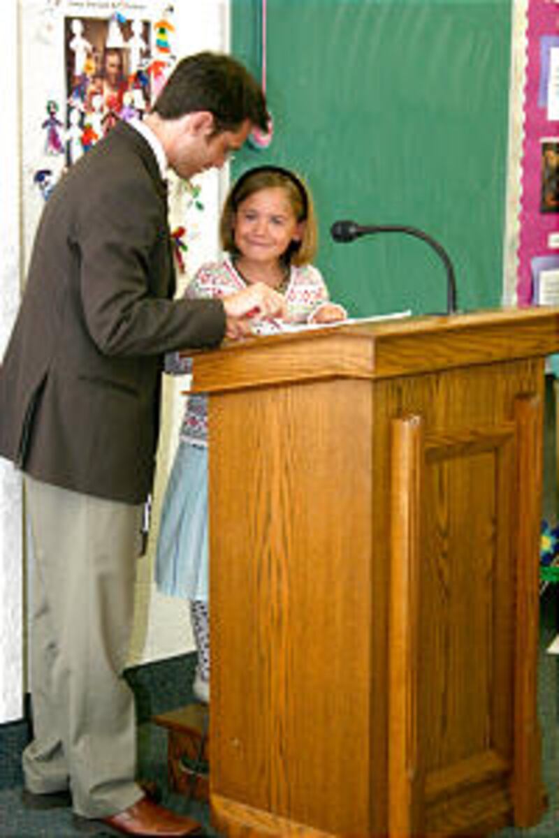 Thomas Glenn prompts daughter Bronwyn during Primary talk in Sunset Ward.