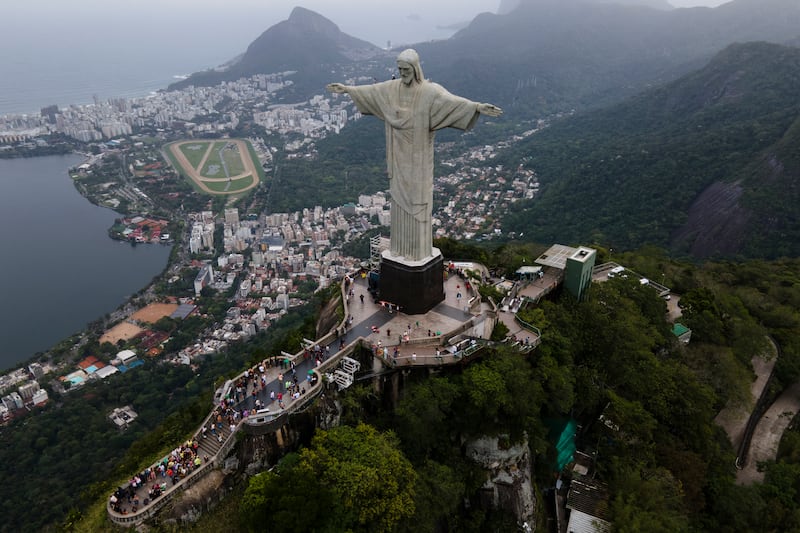In this aerial image taken with a drone, the Christ the Redeemer statue stands above Rio de Janeiro, Brazil, Friday, Oct. 8, 2021, one week before its 90th anniversary. (AP Photo/Lucas Dumphreys)