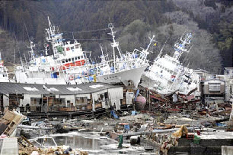 Ships are left aground among destroyed houses in Kesennuma, Miyagi Prefecture, five days after the e