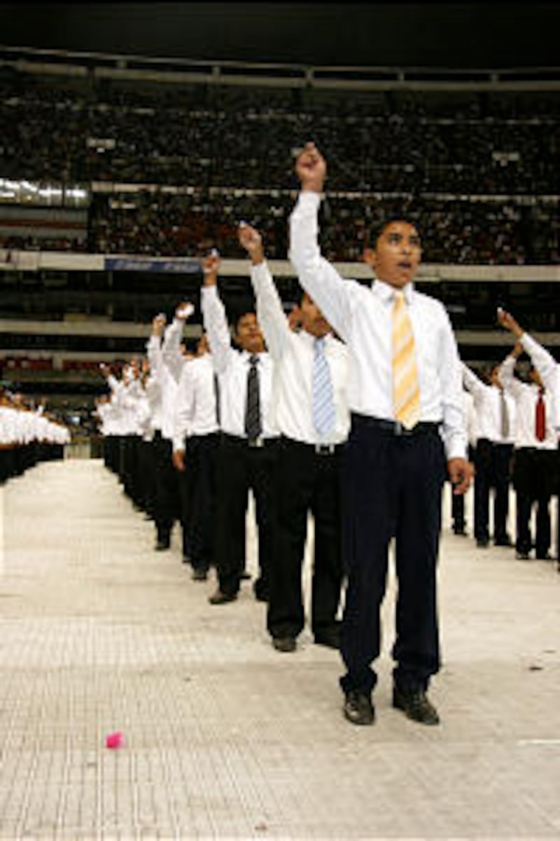 Several rows of students from the Church-owned Benemerito de las Americas Academy sing "Bring the W