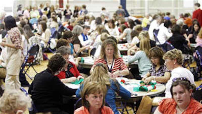 Women sew Christmas stockings during the BYU Women's Conference evening of service in Provo Thursd