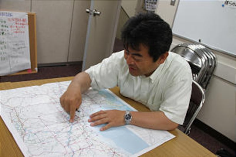 Bishop Tatsuya Otomo of the Nagamachi Ward shows how he accounted for members at March 11 earthquake