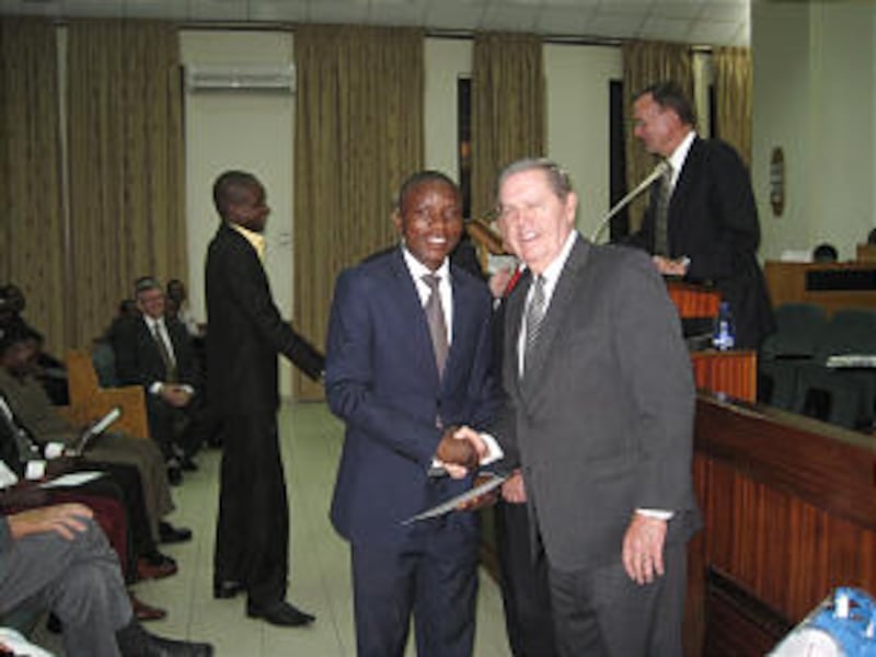 Elder Jeffrey R. Holland shakes hand of a member who received a certificate from LDS Business School