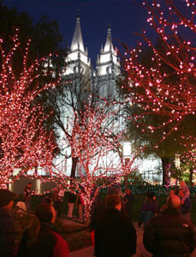 Visitors gets their first look at the lights on Temple Square after they were turned on as part of a